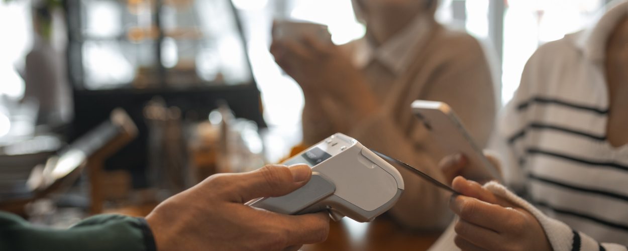 person-using-nfc-technology-pay-restaurant